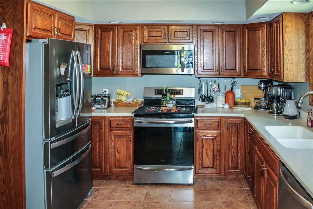 9 South Country Club Road Mattoon, IL 61938 - Photo 8 of 20 a kitchen with stainless steel appliances granite countertop a refrigerator stove and sink