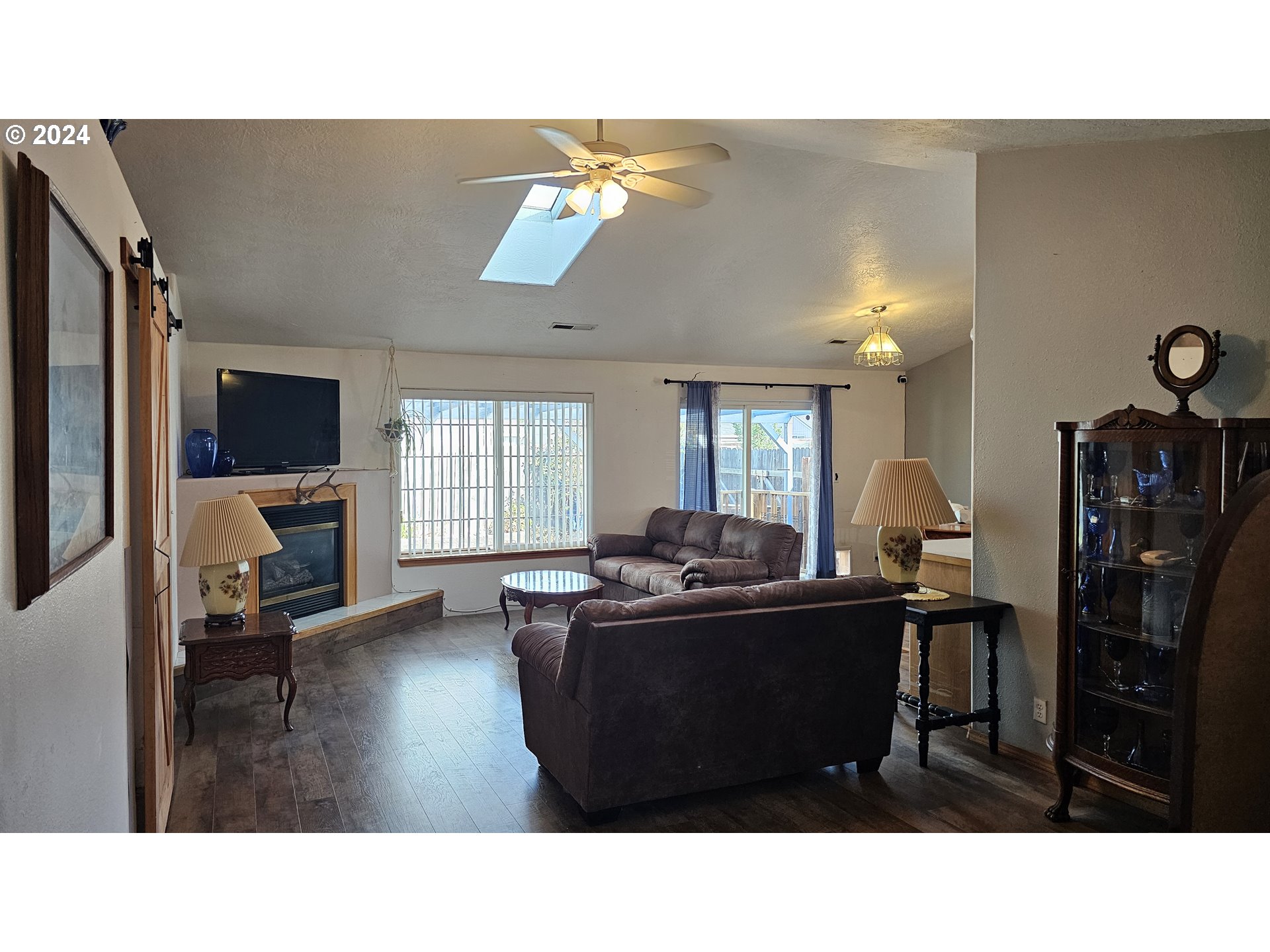 4072 Forsythia Street Springfield, OR 97478 - Photo 12 of 23 a living room with furniture a flat screen tv and kitchen view