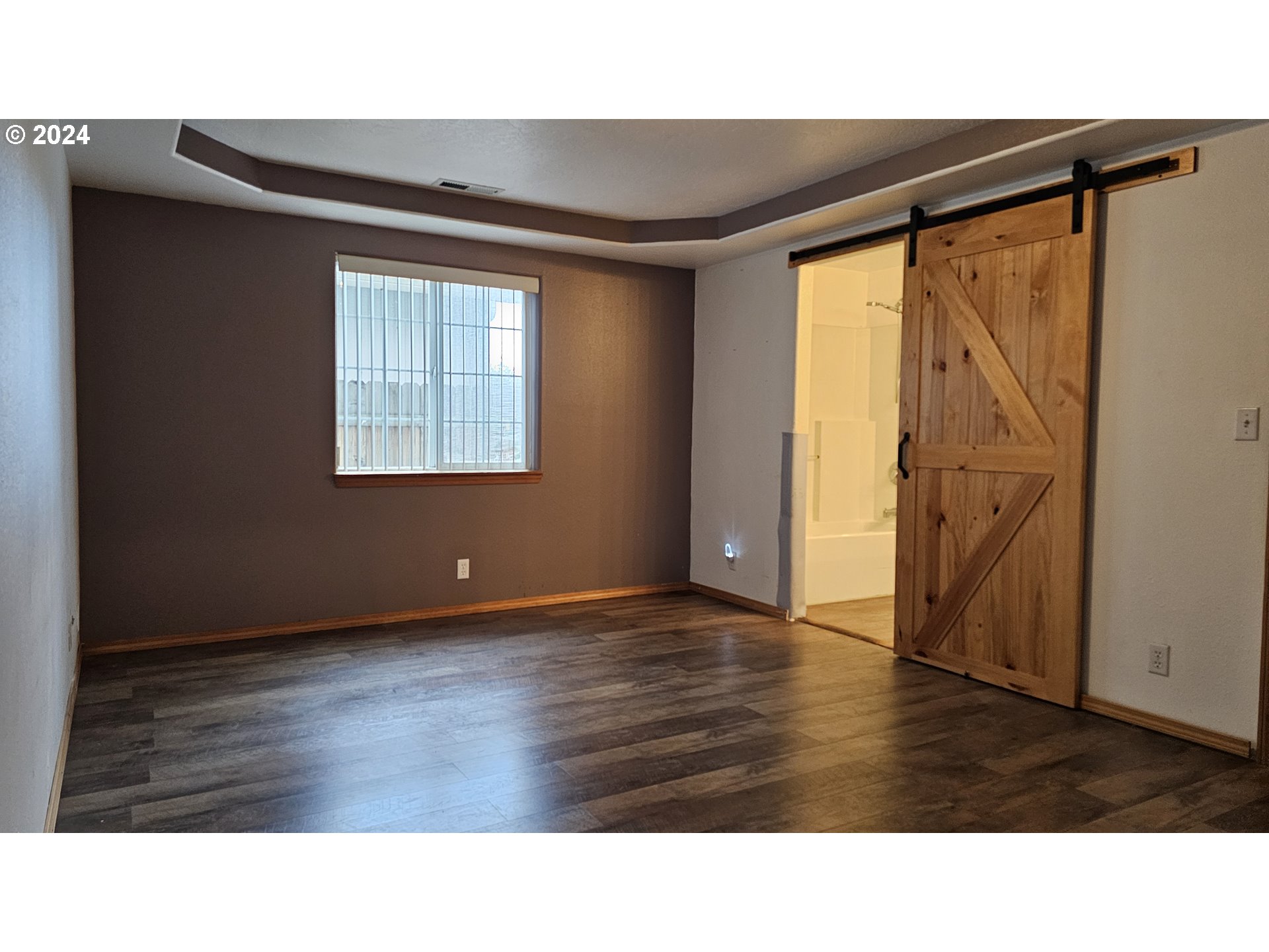 4072 Forsythia Street Springfield, OR 97478 - Photo 19 of 23 a room with wooden floor and windows