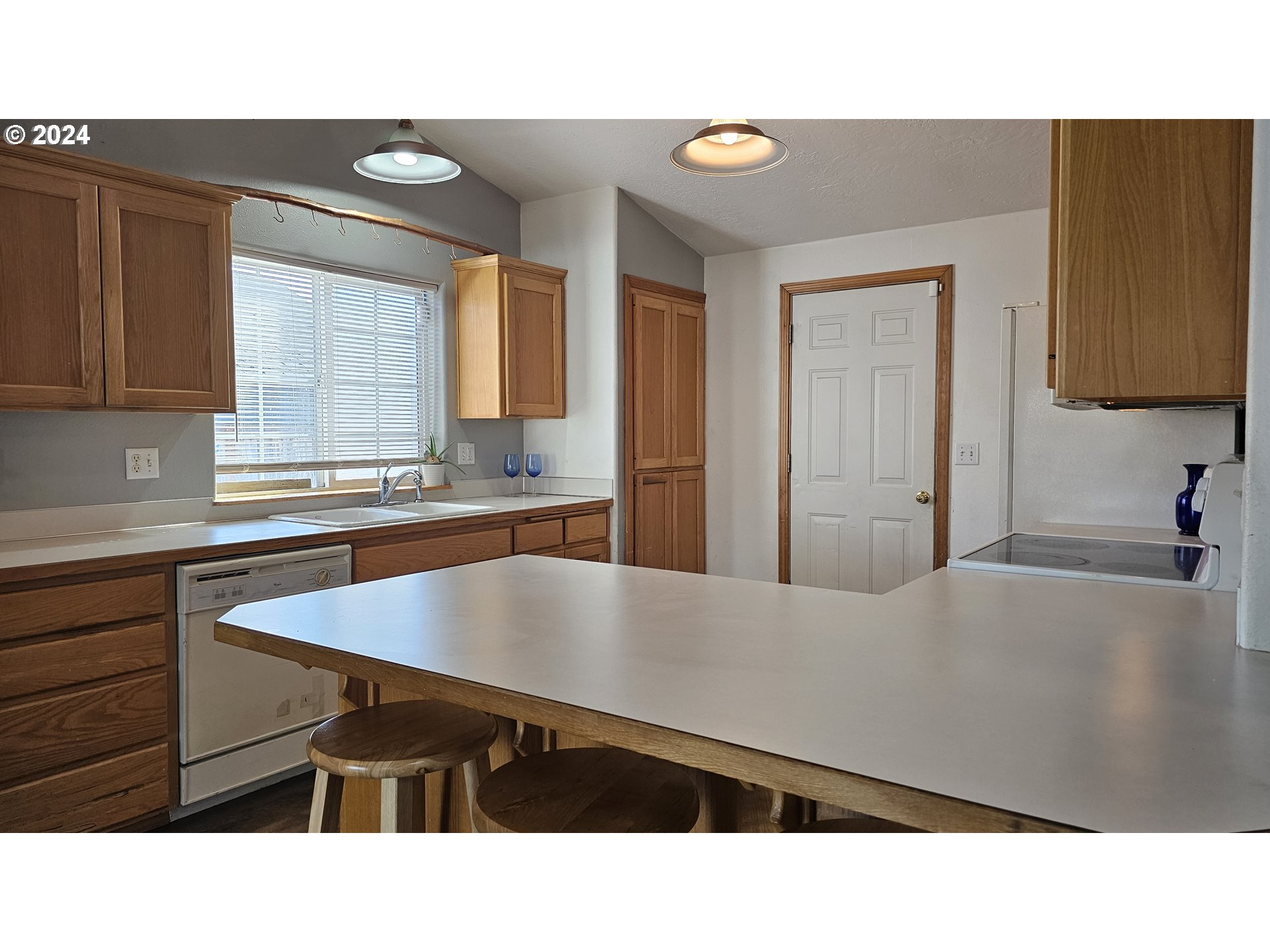 4072 Forsythia Street Springfield, OR 97478 - Photo 4 of 23 a kitchen with a sink cabinets and window