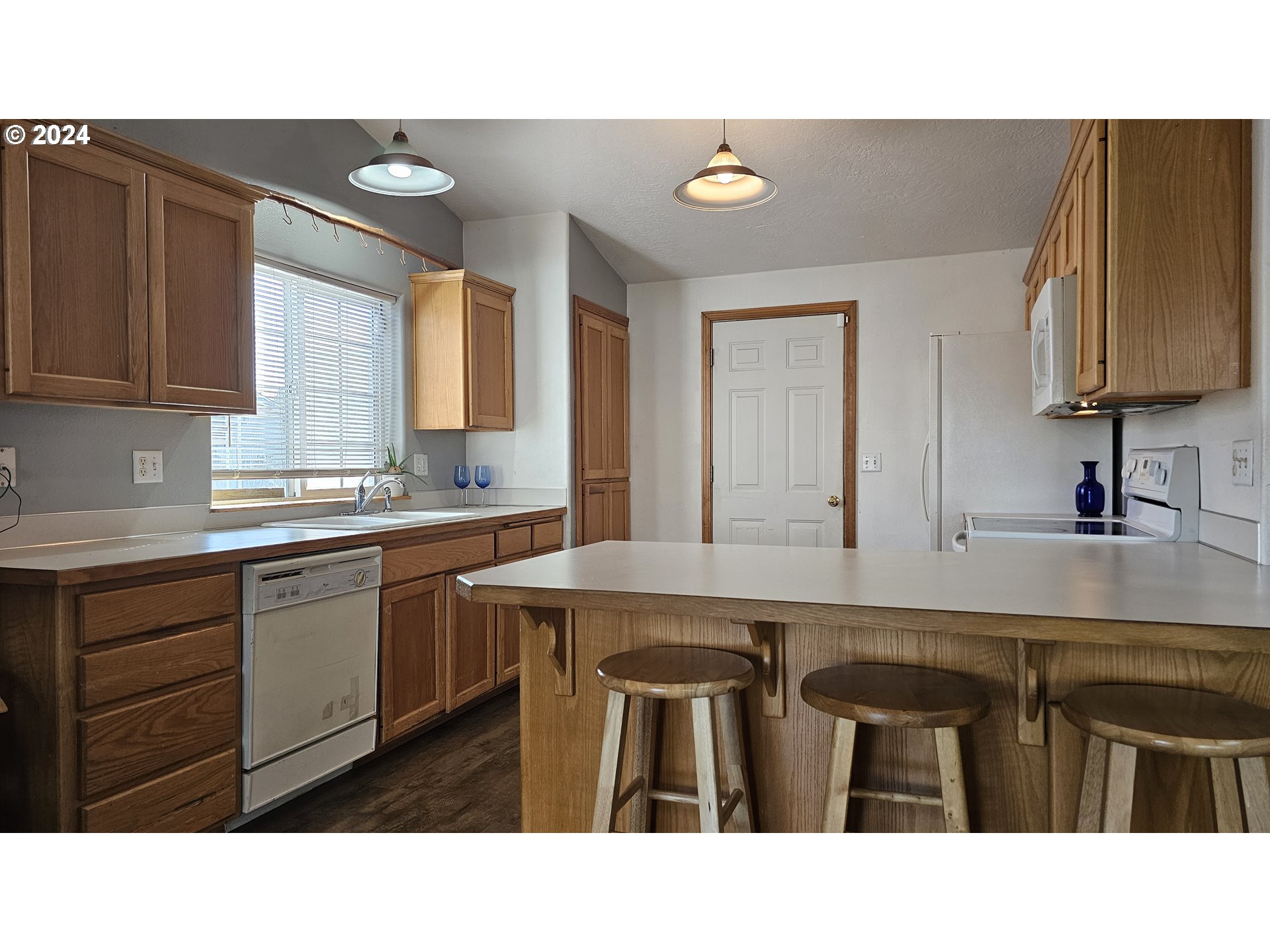 4072 Forsythia Street Springfield, OR 97478 - Photo 5 of 23 a kitchen with a sink and cabinets