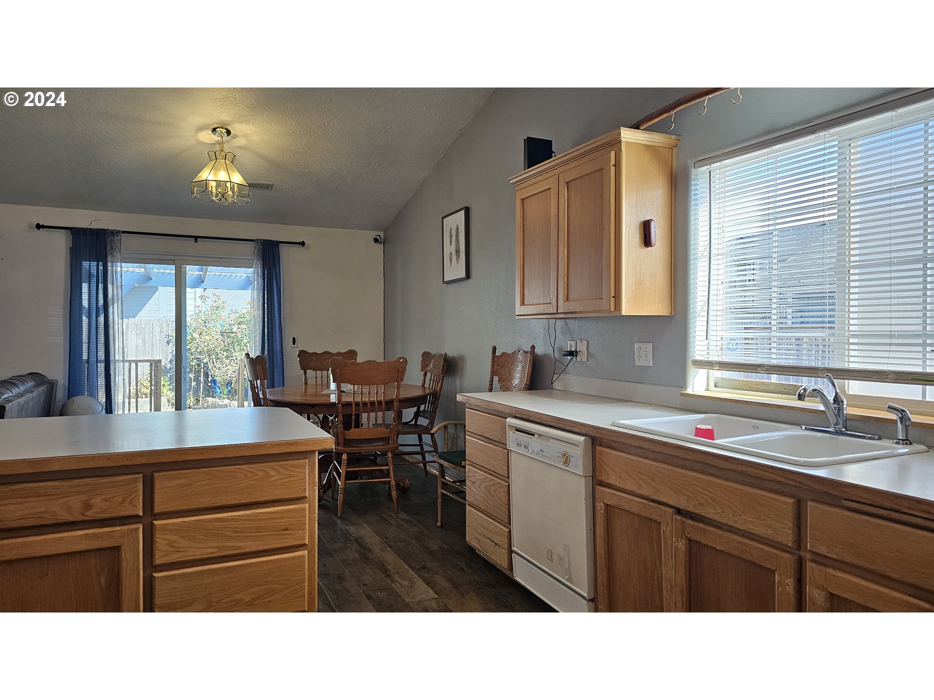 4072 Forsythia Street Springfield, OR 97478 - Photo 8 of 23 a kitchen with a sink cabinets and window