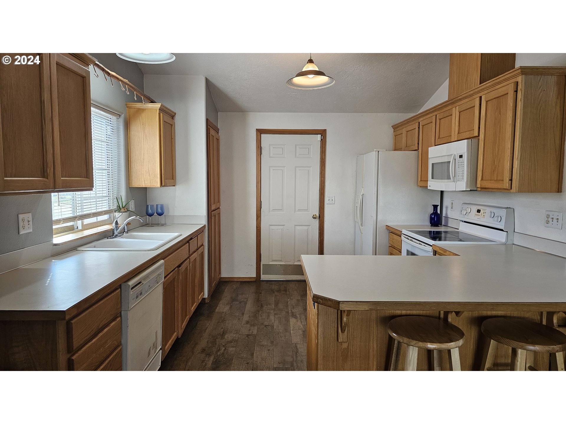 4072 Forsythia Street Springfield, OR 97478 - Photo 9 of 23 a kitchen with a sink cabinets and window