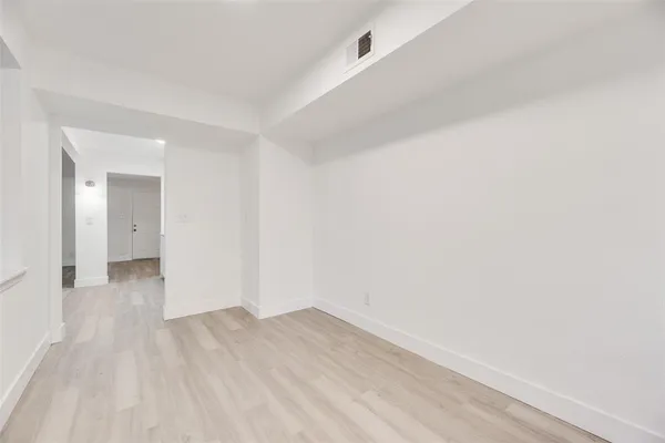 a view of a room with wooden floor