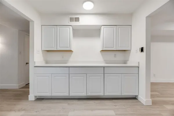a kitchen with white cabinets
