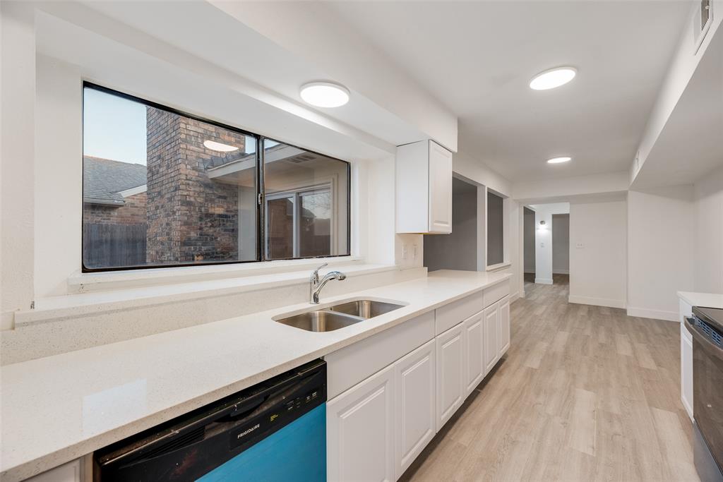 4512 Larner Street The Colony, TX 75056 - Photo 16 of 29 a kitchen with a sink and large window