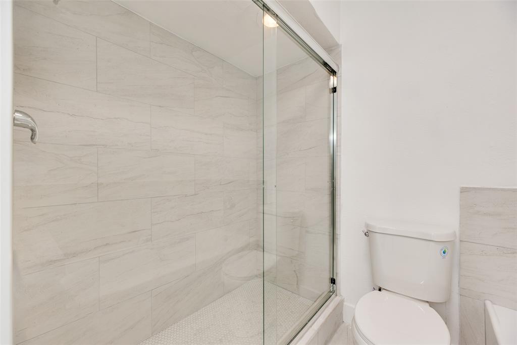 4512 Larner Street The Colony, TX 75056 - Photo 19 of 29 a bathroom with a toilet and a shower