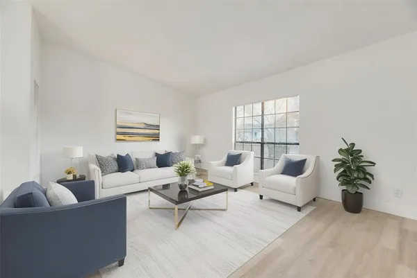 a living room with furniture and a potted plant
