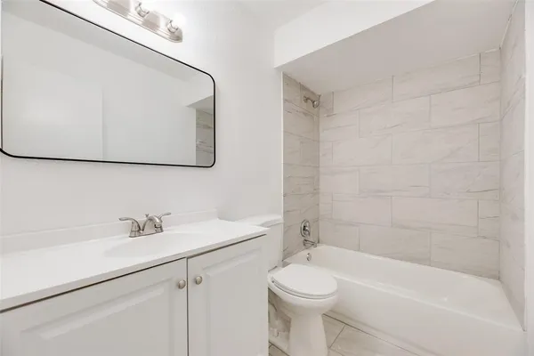 a bathroom with a sink a toilet and bathtub