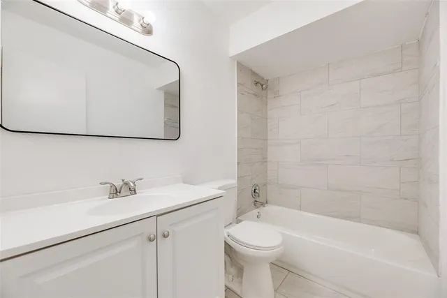 a bathroom with a sink a toilet and bathtub