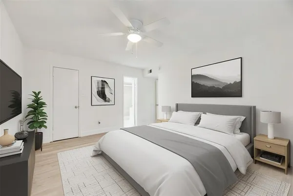 a bedroom with a bed and a flat screen tv