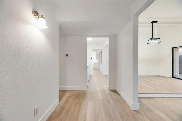 a view of hallway with wooden floor