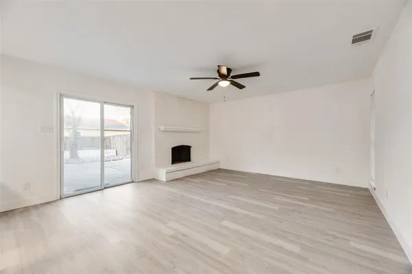 a view of an empty room with glass door