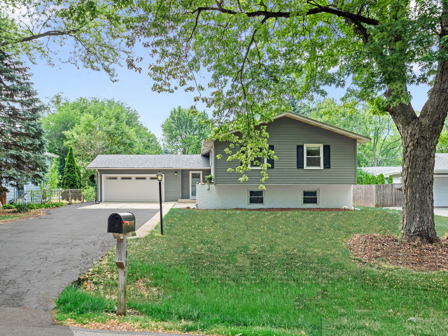 N208 Calvin Court Winfield, IL 60190 - Photo 2 of 30 a view of a house with a yard and a large tree
