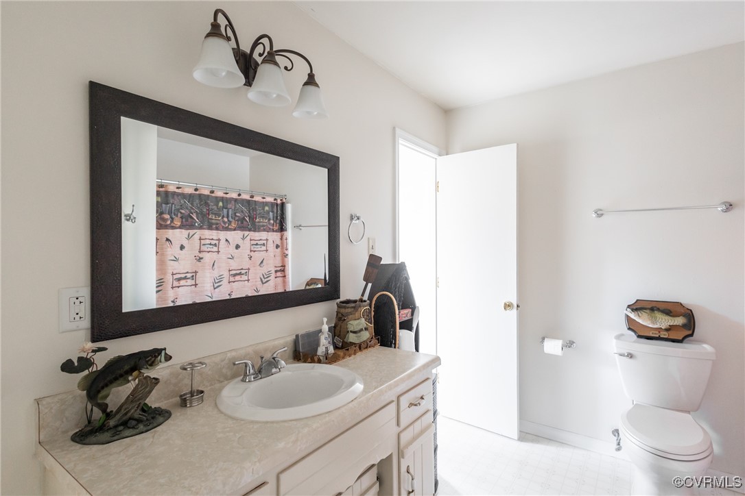 12901 Branders Bridge Road Chester, VA 23831 - Photo 17 of 28 a bathroom with a sink a toilet and mirror