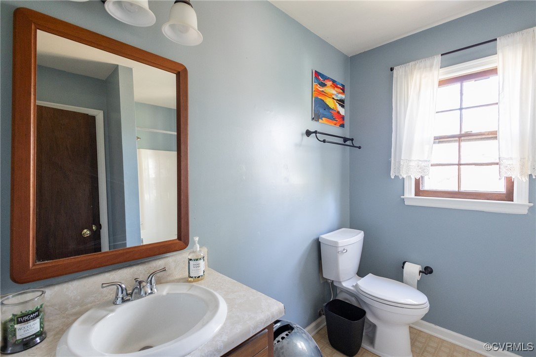 12901 Branders Bridge Road Chester, VA 23831 - Photo 20 of 28 a bathroom with a toilet a sink and a window