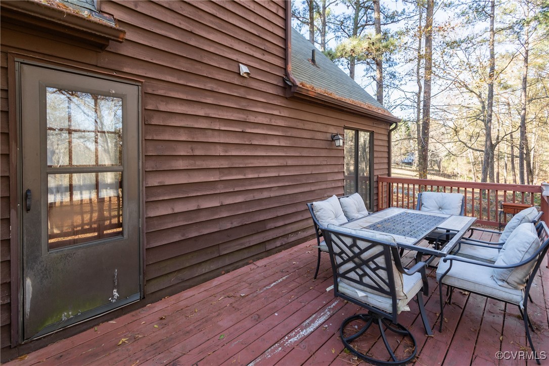 12901 Branders Bridge Road Chester, VA 23831 - Photo 25 of 28 a view of a patio with table and chairs with wooden floor and fence