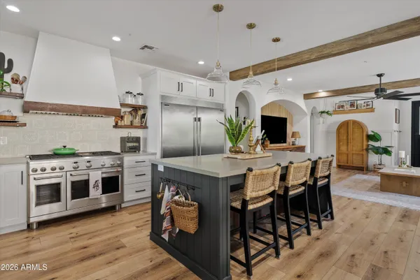a kitchen with stainless steel appliances a stove a sink and a refrigerator