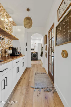 a large white kitchen with a large window and stainless steel appliances