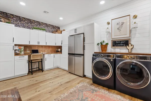 a kitchen with a refrigerator sink and cabinets