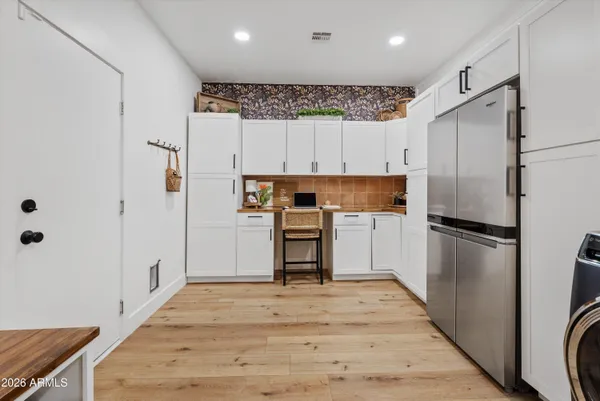 a kitchen with stainless steel appliances a refrigerator sink and cabinets