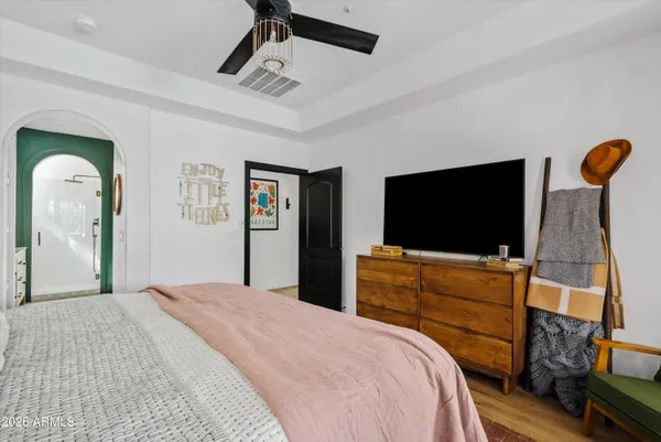 a bedroom with a bed and a flat screen tv