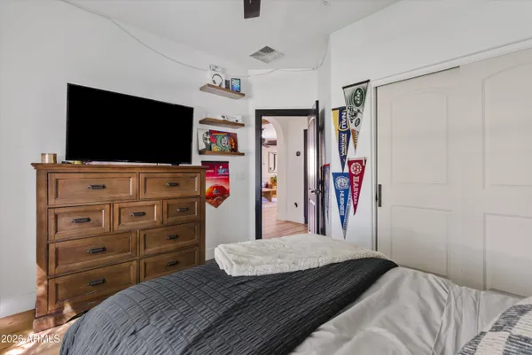 a bedroom with a bed and a flat screen tv in it
