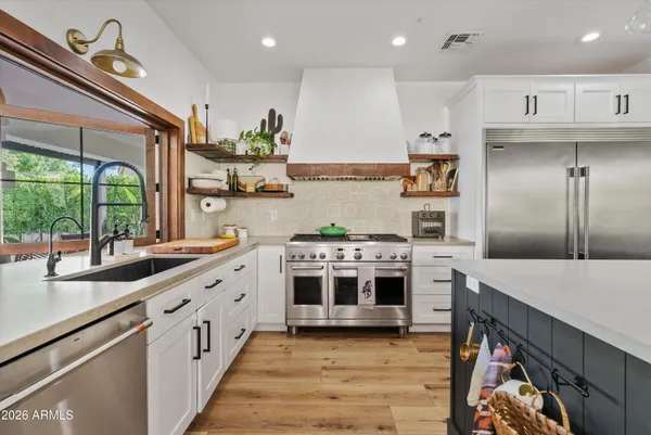 a kitchen with stainless steel appliances granite countertop a stove and a sink