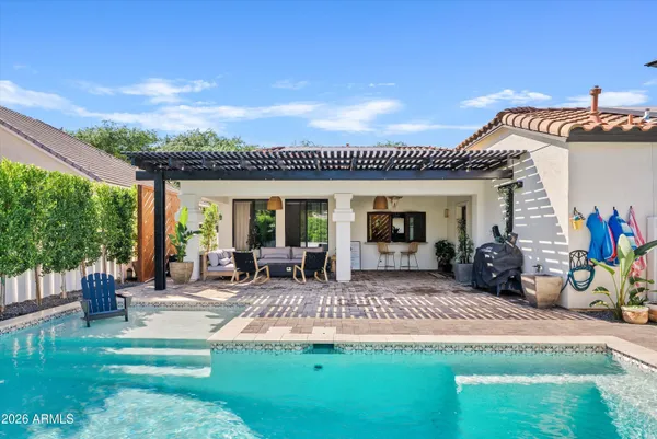 a view of a house with backyard porch and sitting area