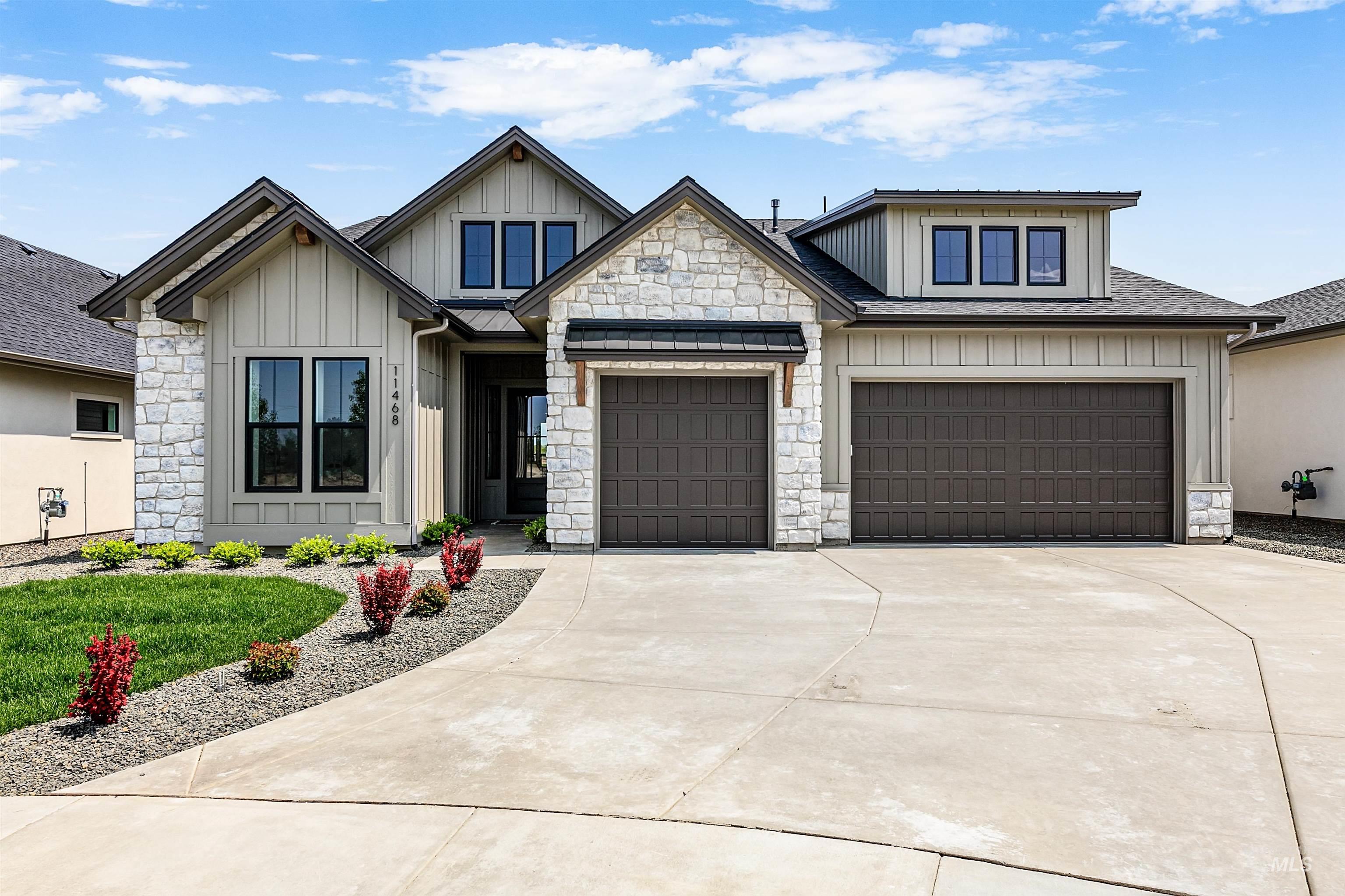 11468 South Saylis Place Kuna, ID 83634 - Photo 1 of 38 View of front of house featuring board and batten siding, stone siding, concrete driveway, and an attached garage