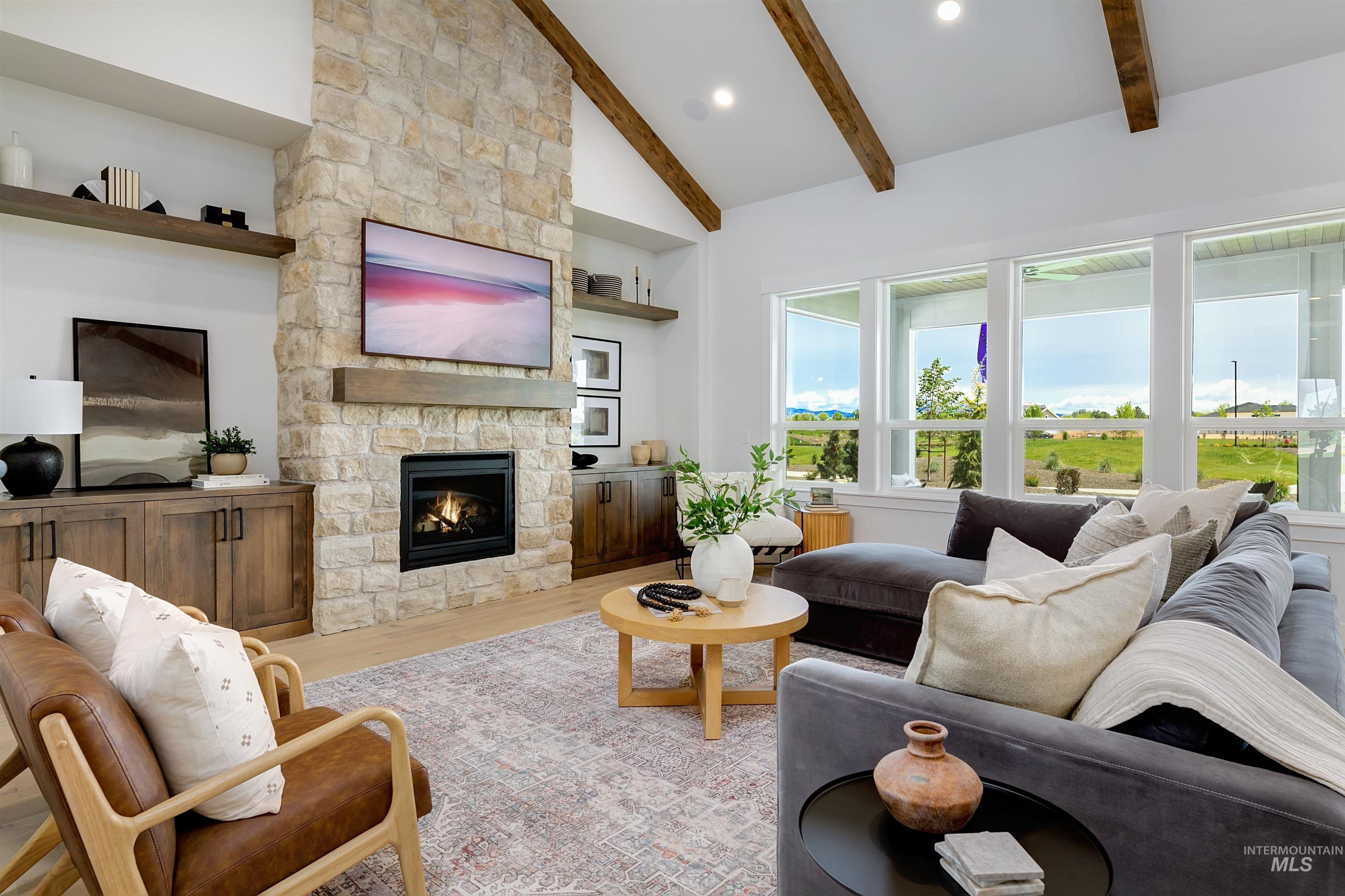11468 South Saylis Place Kuna, ID 83634 - Photo 15 of 38 Living area featuring light wood-style flooring, a fireplace, vaulted ceiling, and recessed lighting