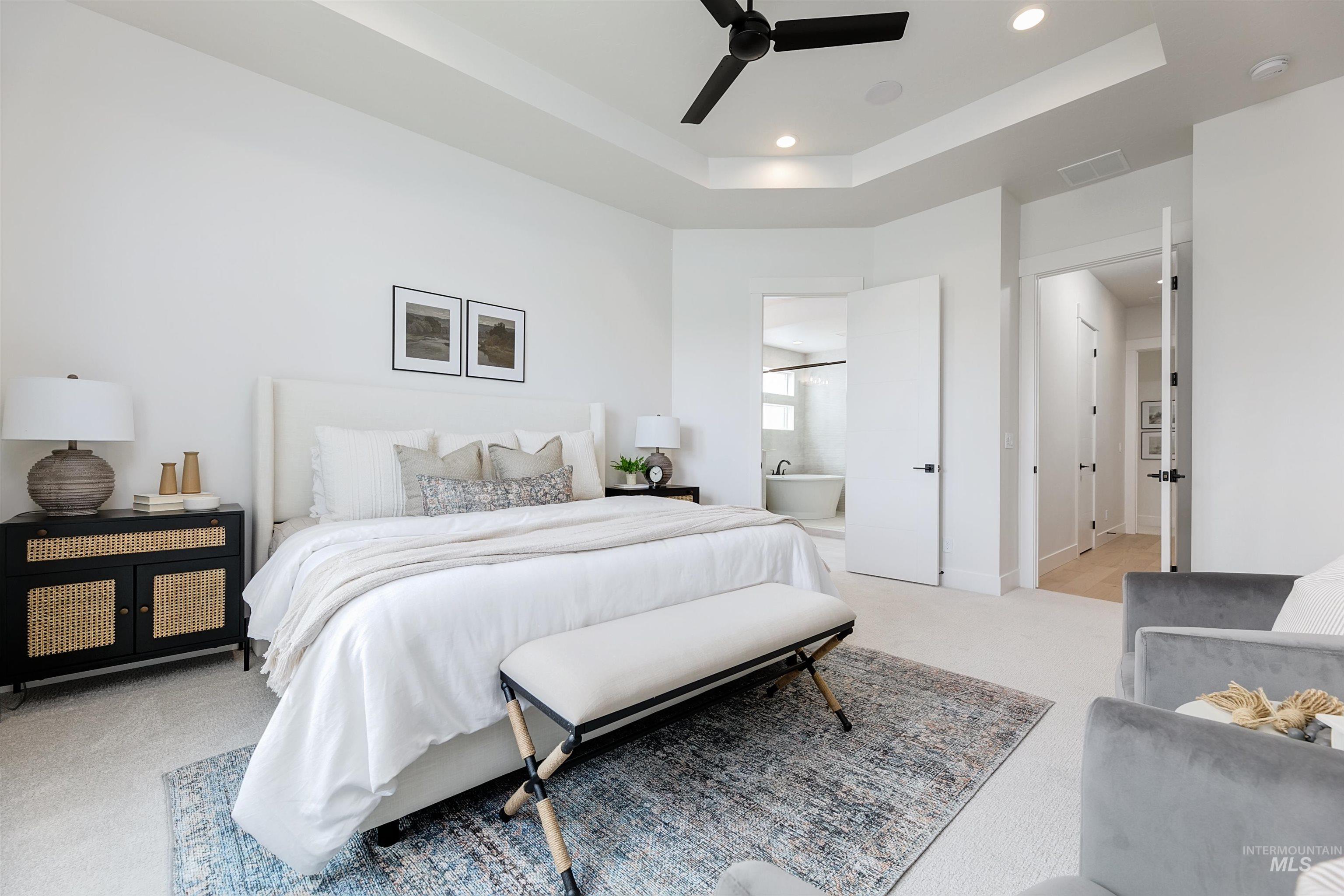 11468 South Saylis Place Kuna, ID 83634 - Photo 19 of 38 Bedroom with a tray ceiling, light colored carpet, recessed lighting, ceiling fan, and ensuite bathroom