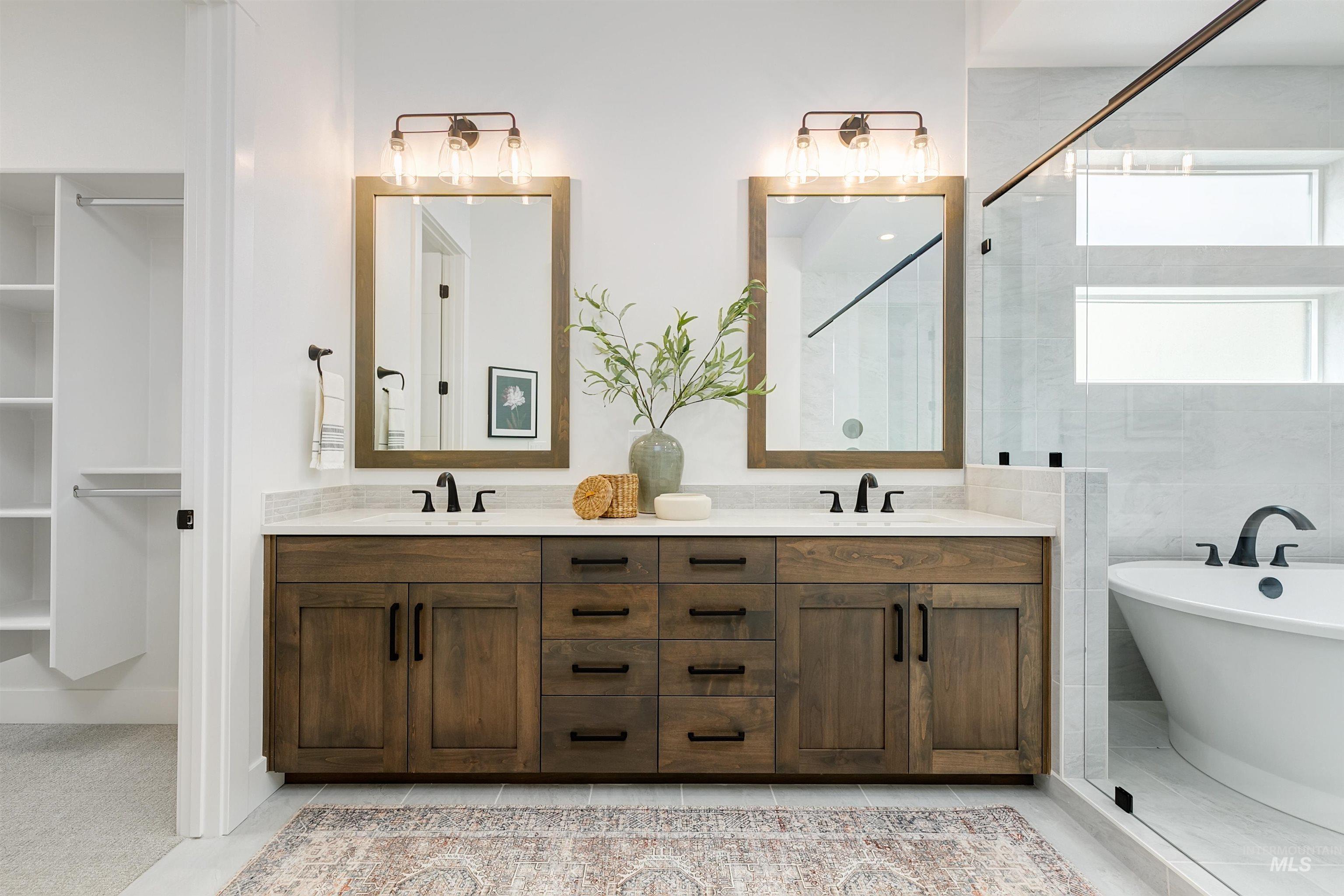 11468 South Saylis Place Kuna, ID 83634 - Photo 20 of 38 Full bathroom featuring double vanity, a freestanding bath, and tiled shower