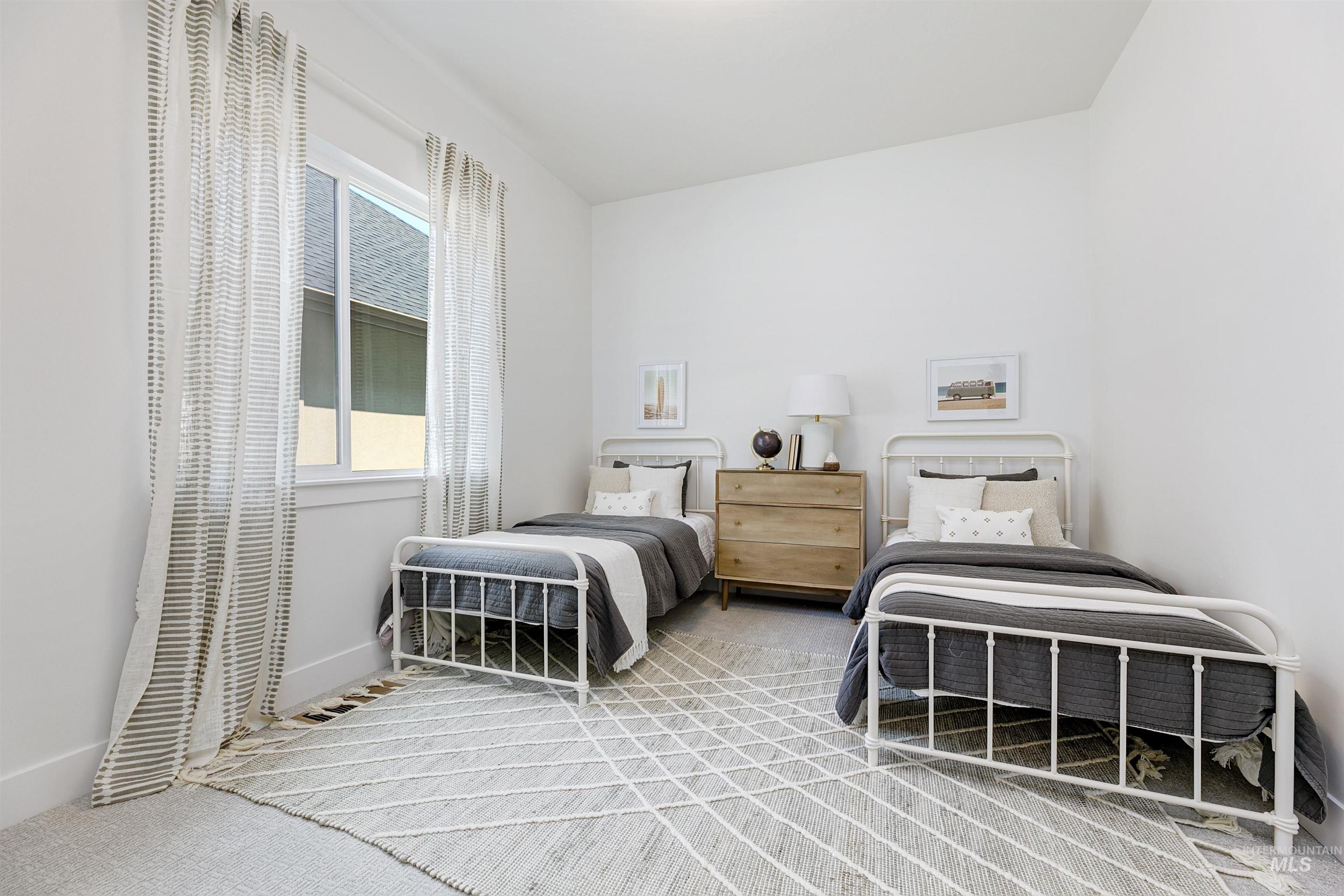 11468 South Saylis Place Kuna, ID 83634 - Photo 26 of 38 Bedroom with light carpet and baseboards