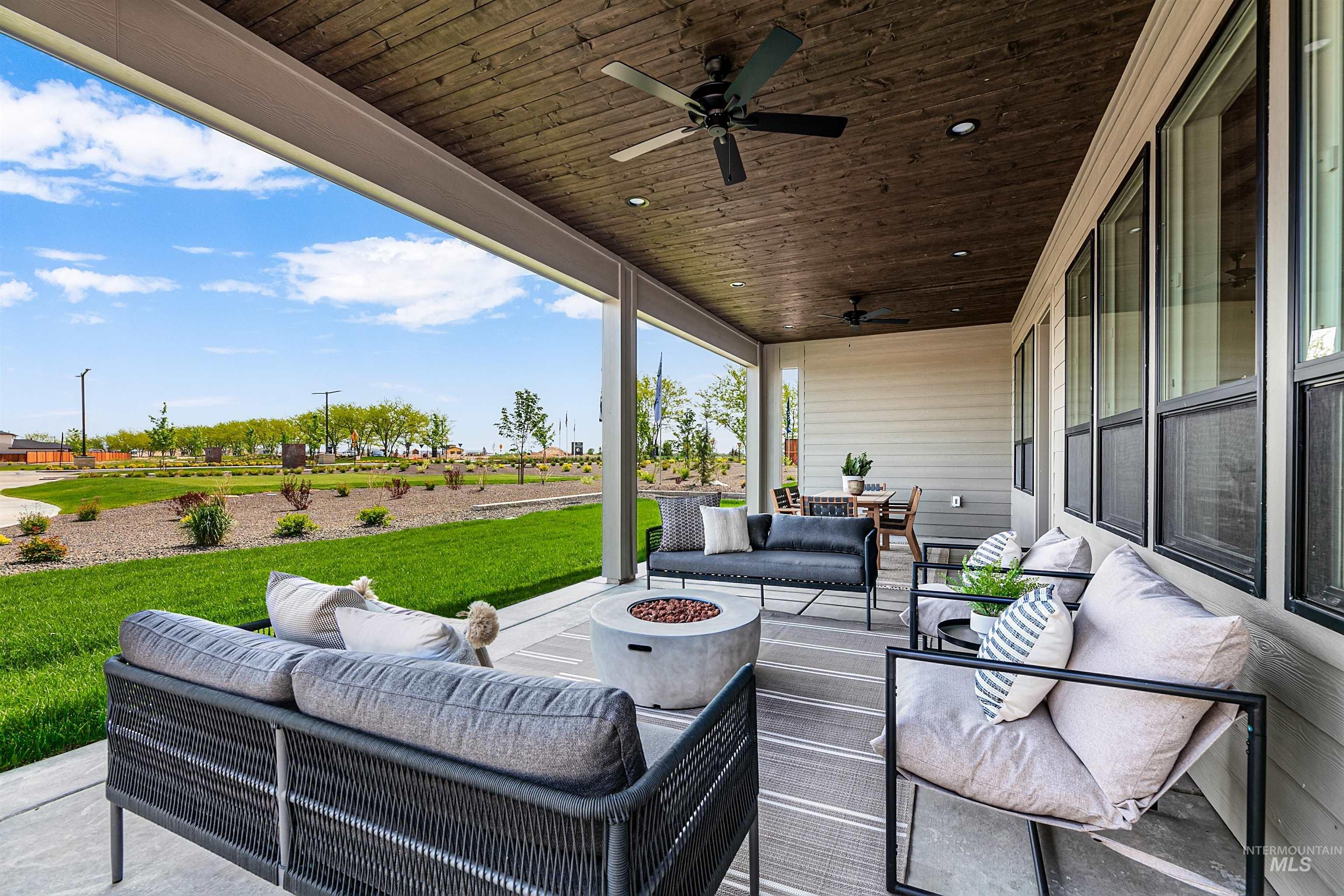 11468 South Saylis Place Kuna, ID 83634 - Photo 31 of 38 View of patio / terrace with an outdoor living space with a fire pit and a ceiling fan