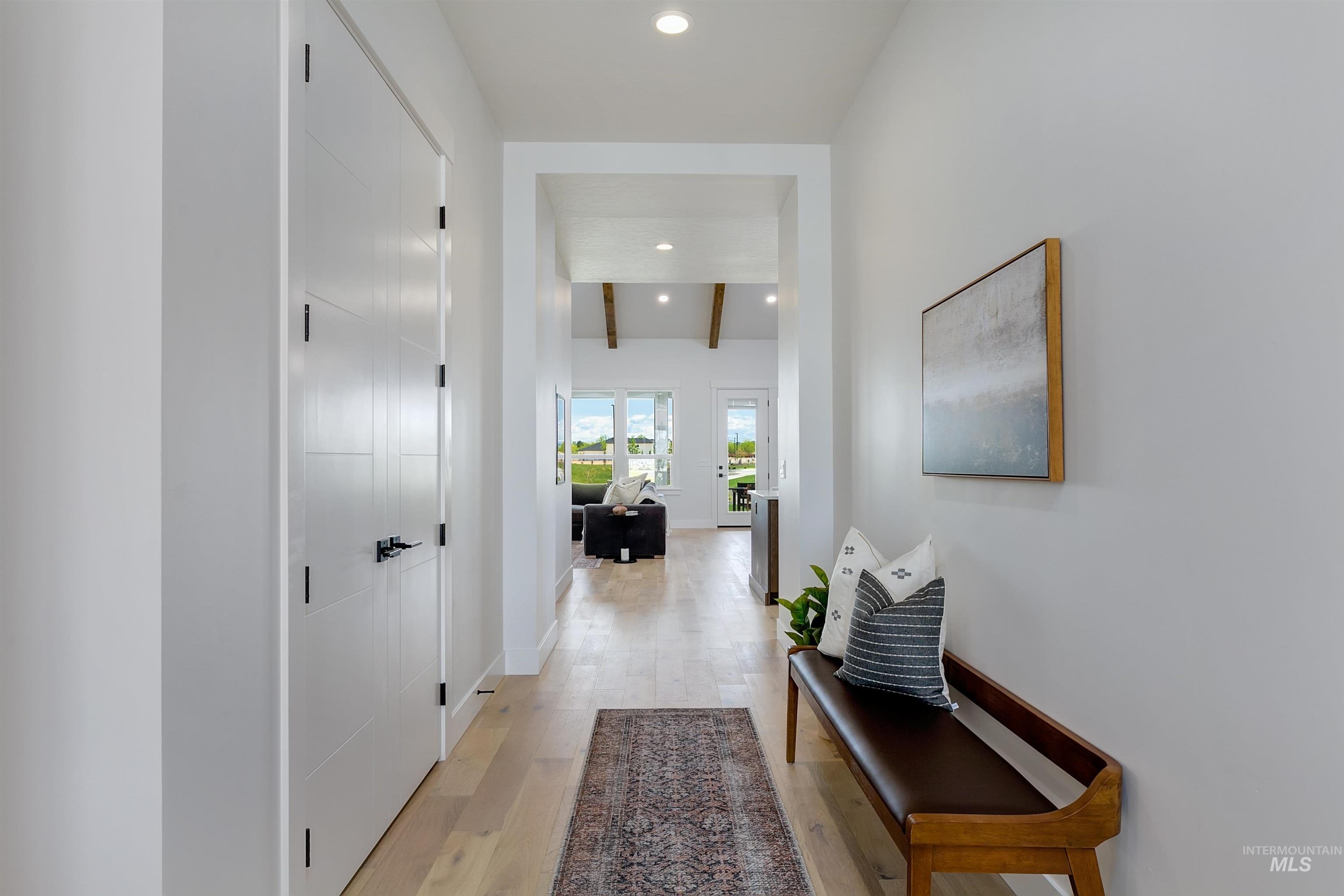 11468 South Saylis Place Kuna, ID 83634 - Photo 4 of 38 Corridor with light wood-type flooring, recessed lighting, and beamed ceiling