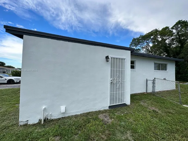 a backyard of a house with dishwasher and outdoor seating