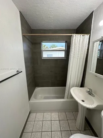 a bathroom with a sink a bath tub and a shower