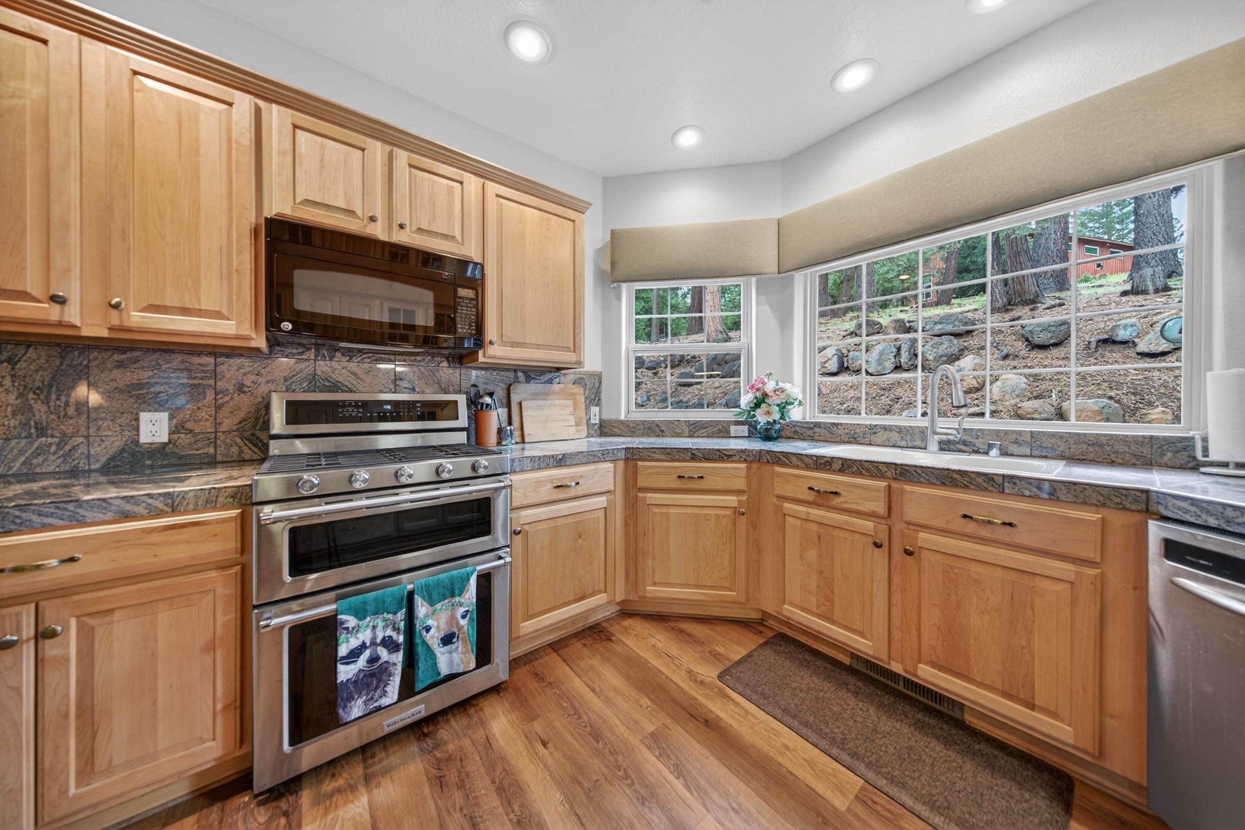 1017 Timber Ridge Road Lake Almanor, CA 96137 - Photo 13 of 45 a kitchen with stainless steel appliances granite countertop a stove sink microwave and window