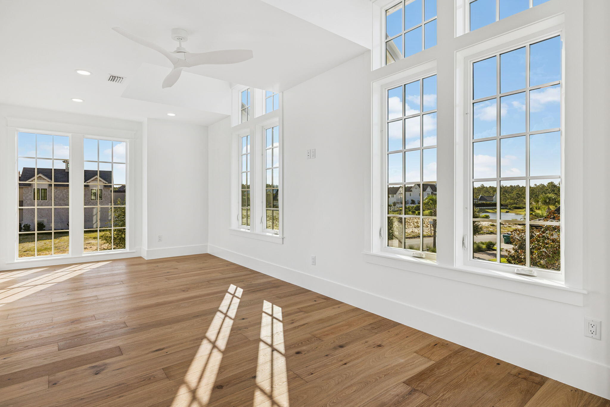 155 Golfridge Dr Inlet Beach Inlet Beach, FL 32461 - Photo 57 of 99 a view of an empty room with wooden floor and windows