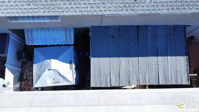 a view of a house with a barbeque and wooden roof