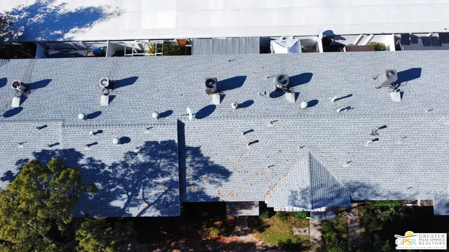 an aerial view of multiple houses with yard