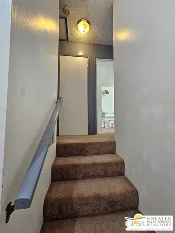 a bathroom with a toilet and mirror