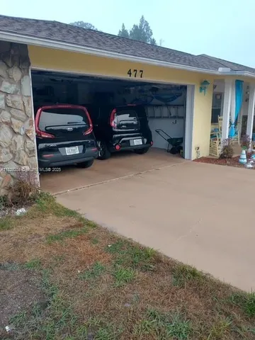 a front view of a house with parking space