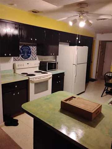 a kitchen with a sink appliances and cabinets