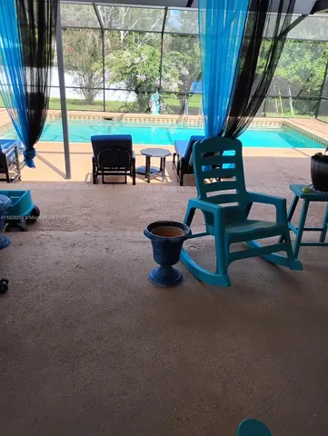 a building outdoor space with patio furniture and potted plants