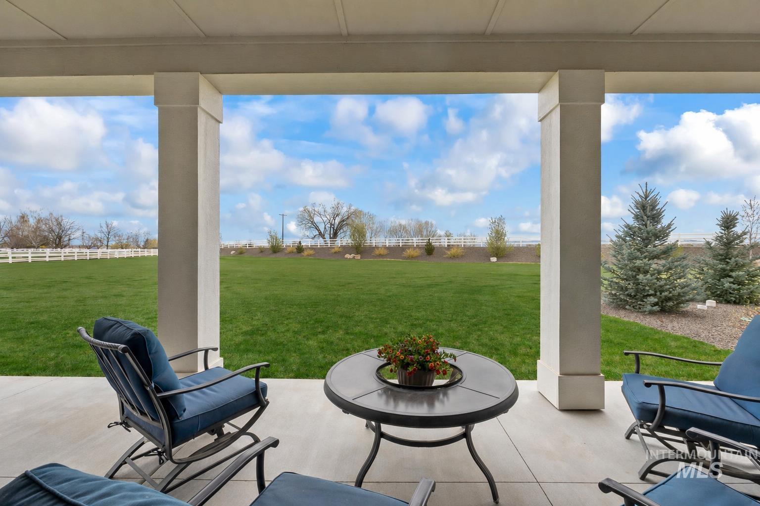 24696 Regal Road Middleton, ID 83644 - Photo 19 of 24 Covered patio with concrete flooring, featuring substantial support columns and a clear expanse of green lawn