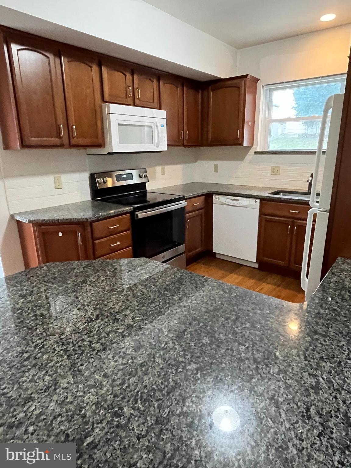 5 Ehst Road Bechtelsville, PA 19505 - Photo 7 of 23 a kitchen with stainless steel appliances granite countertop a stove a sink dishwasher and a microwave oven with cabinets