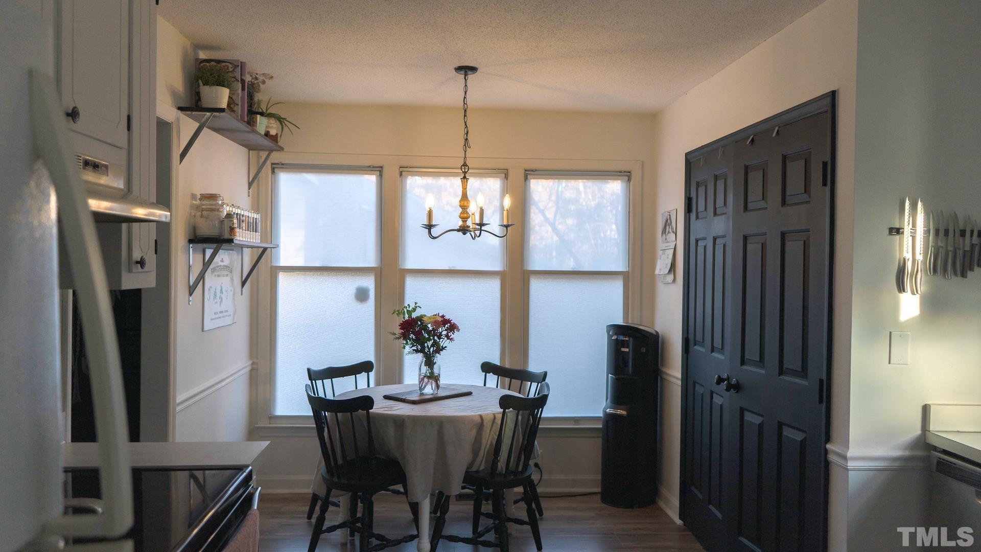 7921 Mandrel Way Raleigh, NC 27616 - Photo 11 of 32 a view of a dining room with furniture window and wooden floor