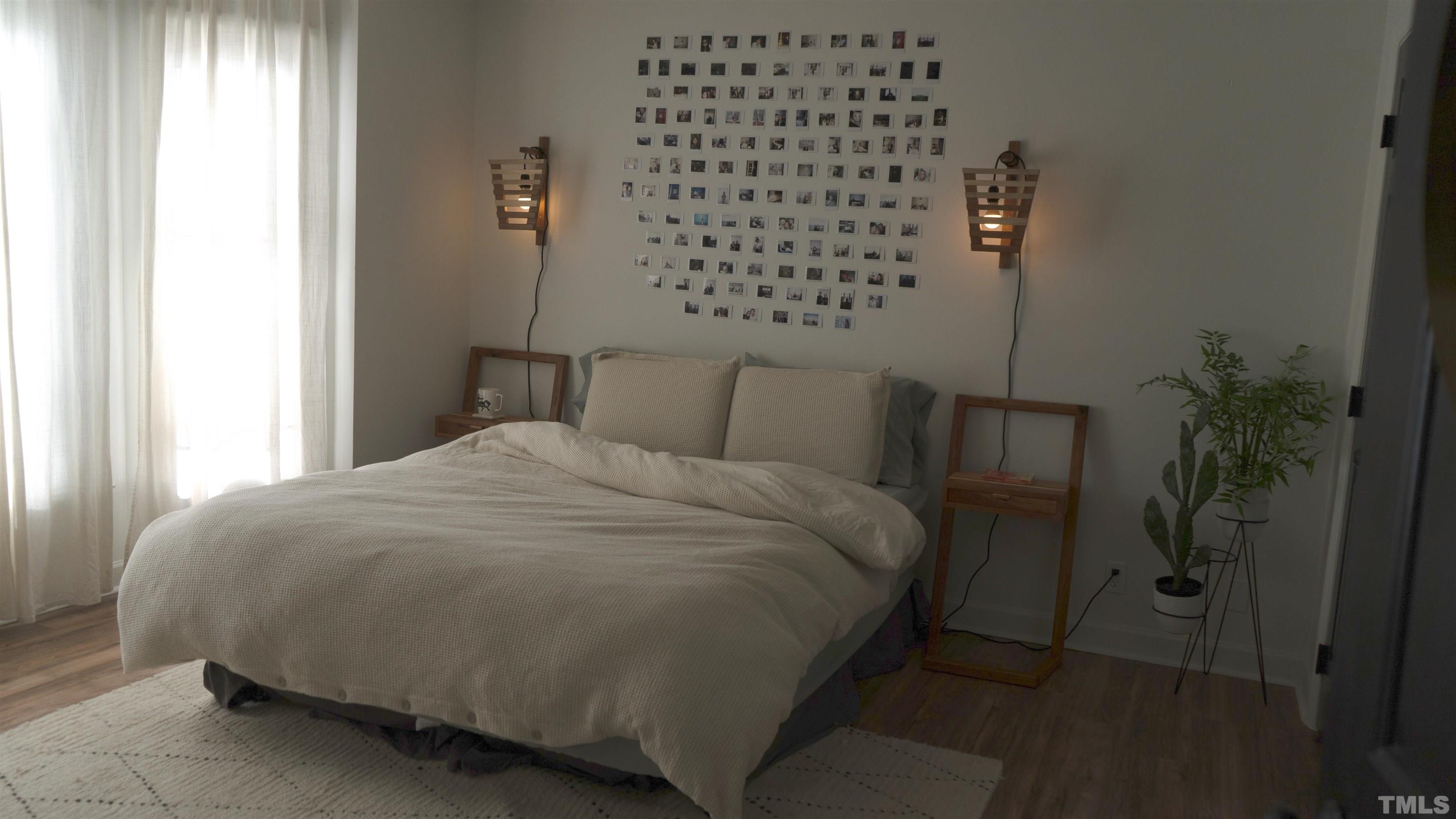 7921 Mandrel Way Raleigh, NC 27616 - Photo 17 of 32 a bedroom with a bed and a potted plant